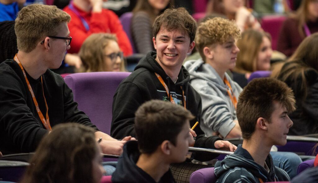 male ro student laughing with other student